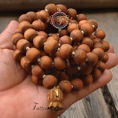 "📿Tulsi Mala handcrafted with Brown Tulsi beads. Suspended in the center is the engraved \"Krishna & Radha\" Guru Bead. When someone wears the tulsi mala, around your neck or around your wrist, you feel protected and focussed. It actually goes a long way in helping you deal with the stress of modern life.📿 🚪 Dimensions ( Approximately ) 🚪 📏Bead size: 11 MM - 12 MM 📏No. of beads: 108 Mala Bead + 1 Guru Bead 📏Mala Necklace Length: 50.0 - 51.0 inches 🚪 Pure Tulsi Beads Sourced from Vrindava Spiritual Wooden Beads Jewelry For Meditation, Holistic Healing Mala With Wooden Beads, Holistic Wooden Beads Mala For Rituals, Artisan 108 Beads For Meditation, Holistic Wooden Mala For Rituals, Artisan Wooden Beads For Meditation, Artisan Wooden Meditation Beads, Artisan Mala With Round Beads For Meditation, Spiritual Polished Beads For Meditation