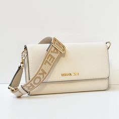 New With Tag Michael Kors Jet Set Item Large Zip Around Wallet Crossbody Bag Pebbled Leather Light Cream 100% Authentic Retail: $348.00 Plus Tax **Please See The Measurement For The Size* No Dust Bag Michael Kors Logo At Front Flap Closure Smooth Leather On Flap Top Closure Exterior Back Zip Pocket Gold Toned Hardware Custom Fabric Lining 2 Open Compartments And A Middle Zip Around Middle Compartment: 12 Card Slots, 4 Bill Pockets 8"(L) X 4.75"(H) X 2"(D) Strap: 23" Adjustable Very Clean, Smoke- Michael Kors Jet Set Large Crossbody Bag, Large Crossbody Bag, Michael Kors Logo, Large Crossbody Bags, Bag Light, Light Cream, Kors Jet Set, White Bag, Jet Set