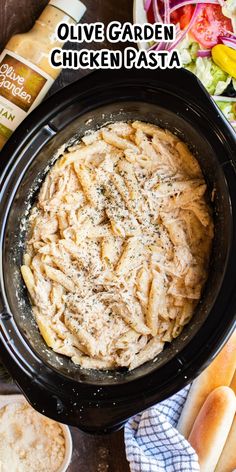 an image of a bowl of pasta in the crock pot with text overlay that reads olive garden chicken pasta