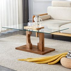 a glass coffee table sitting on top of a rug