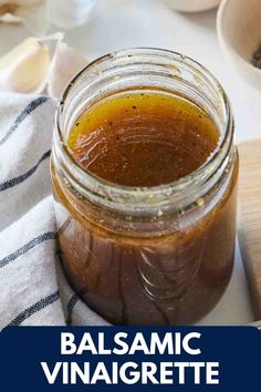 balsamic vinaigrette in a glass jar on a table with spoons