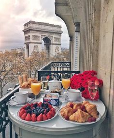 breakfast is served on the balcony overlooking the eiffel tower in paris, france