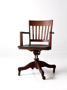 an old wooden chair sitting on top of a small desk stool with casteors and wheels