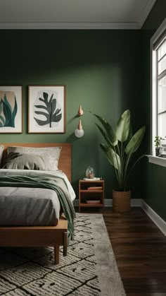 a bedroom with green walls and wooden floors, two paintings on the wall above the bed