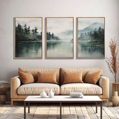 a living room with three paintings on the wall and two coffee tables in front of it