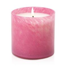 a pink candle sitting on top of a white table