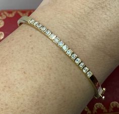 14k Yellow Gold Diamond Bangle 7.25” Lavish her with luxury with this stunning bracelet! There are 15 rounds diamonds approximately 3/4 - 1 carat approx. VS-SI and color E-F. The inside circumference measures approx. 7.25”. Stamped 14k KD 1.03 with a serial number. The 1.03 stamp is most likely for the carat weight of the piece. Weighs 14 grams. Includes a beautiful gift box. A gorgeous bracelet! Note: Diamond quality and carat weight can vary slightly in opinion (please allow for a slight varia Wedding Diamond Bangle Channel Set, Classic Channel Set Diamond Bracelet For Wedding, Classic Hallmarked Cuff Bracelet For Wedding, Classic Wedding Bangle With Vvs Clarity, Classic Diamond Cuff Bracelet For Wedding, Classic Wedding Cuff Bracelet With Single Cut Diamonds, Classic Wedding Cuff Bracelet With Hand Set Details, Classic Hand Set Cuff Bracelet For Wedding, Adjustable Wedding Diamond Bracelet With Single Cut Diamonds