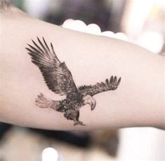 an eagle tattoo is shown on the arm