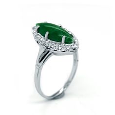 This ring has a gorgeous green natural cabochon marquise cut Green Jade. It is the perfect statement ring for everyday wear. It is made in 14 karats of white gold. [MATERIALS] Stone: Jade (1) Carat: Approx.2.50 Color: Green Cut: Cabochon marquise Clarity: Slight imperfections Setting: Prong Measurement of the stone: 17.50 mm X 8.0 mm Metal: 14 karats white Gold, 6.0 grams Measurement of the Band: 5.0 mm [ORDERS] All items that are made to order take about 7-12 days to create and ship. [CUSTOM OR Green Marquise Emerald Rings, Green Marquise Emerald Diamond Ring, Marquise Emerald Diamond Ring In Green, Green Marquise Diamond Ring For Formal Occasions, Green Marquise Diamond Ring For Formal Events, Formal Green Marquise Diamond Ring, Green Marquise Cut Emerald Ring, Classic Marquise Emerald Ring, Formal Green Marquise Emerald Ring