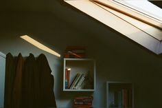 a bookshelf with some books on it and a window in the back ground