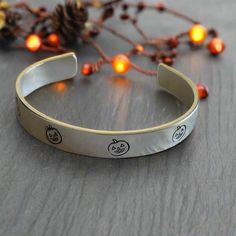 Our spooky pumpkin aluminium adjustable bracelets are the perfect gift for anyone this Halloween, either to send as a gift or keep for yourself. These bangles are lightweight and can be gently bent to fit any size wrist by pinching the ends together.  They are 9mm wide. The bangles are unique as they are made just for you! - making a statement while still being versatile enough to go with any outfit. We handcraft every product to order and aim to have it ready to within 3 to 5 business days.   C Spooky Earrings, Earrings Halloween, Spooky Pumpkin, Letters And Numbers, Adjustable Bracelet, Halloween Gifts, Hand Stamped, Cuff Bracelet, Cuff Bracelets