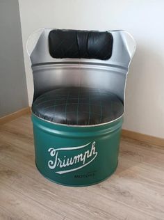 a green and black chair sitting on top of a hard wood floor