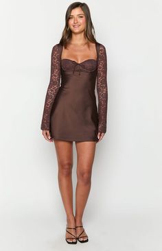 Brown Long Sleeve Mini Dress

How to style:
Make a statement in this stunning mini dress () featuring the sweetest lace details! Our Viola Brown Long Sleeve () Mini Dress is perfect for your next night out or date night (). Elevate the classy silhouette with some gold jewellery and strappy heels for a stunning look!

Features:

  
 * Mini length 
 * Lace overlay on bust 
 * Tie up centre front 
 * Underwire bust cups 
 * Light weight satin body 
 * Invisible zipper on back 
 * Lined body and bust 
 * Unlined sleeves 
 * Bias cut skirt Semi Dresses, Brown Maxi Dresses, Brown Mini Dress, Prom Midi Dress, 60's Dress, Bias Cut Skirt, Brown Long Sleeve, New Years Dress, Strapless Tops