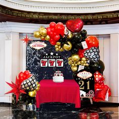 a table with a cake and balloons on it