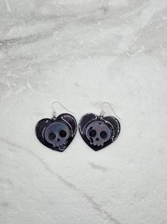 These light-weight skull heart earrings are perfect for the bad-ass babes who fancy a bit of sparkle. Made with resin, these earrings have a holographic effect that will make your outfit POP! Treat yourself to a pair of these skull dangle earrings and upgrade your style game. #Glowup! Ready to ship in 1 - 3 business days Handmade with a shit ton of love from our studio in NJ Edgy Skull-shaped Earrings For Gift, Edgy Nickel-free Skull Earrings, Edgy Skull Shaped Earrings For Gift, Punk Heart-shaped Earrings, Punk Heart-shaped Pierced Earrings, Edgy Skull-shaped Pierced Earrings, Punk Skull Print Earrings Gift, Punk Skull Print Earrings For Gift, Punk Style Skull Print Earrings As Gift