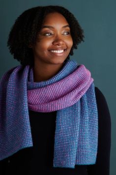 a woman wearing a scarf and smiling at the camera