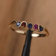 It is a multi stone silver band,delicate stacking ring . The main stone is 2.5 mm round cut. Lab Sapphire / Garnet / Lab Ruby The basic metal is sterling silver plated with rhodium. To change the metal to a solid gold (white/yellow /rose) or platinum is also available, please ask for a quotation if you want. You can also go to my shop Home for more elegant rings: https://www.etsy.com/shop/godjewelry?ref=hdr_shop_menu More rings: https://www.etsy.com/shop/godjewelry?ref=l2-shop-header-avatar Cust 14k Gold Multi-stone Stackable Rings, 14k Gold Multi-stone Stackable Rings For Anniversary, Rose Gold Stackable Rings With Birthstone, Multi-stone Stackable Rings For Promise, Multi-stone Stackable Promise Rings, Stackable Rose Gold Birthstone Ring With Round Band, 14k Gold Three Stone Stackable Rings For Anniversary, Stackable Rose Gold Birthstone Ring, Anniversary Multi-stone Birthstone Ring In Rose Gold