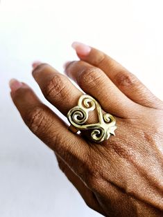 Brass Sankofa Ring, Adinkra Symbol Jewelry, Statement Jewelry, Gold Heart Ring, African Jewelry, Khepera Adornments "Reach Back" solid brass Sankofa ring is a beautiful depiction of the Adinkra symbol of Ghana, West Africa. Sankofa symbol approx. 1 3/4 length.  Sankofa meaning: "We must go back and reclaim our past so we can move forward; so we understand why and how we came to be who we are today." **Sankofa is a Twi word from the Akan tribe of Ghana. The Akan people have a richly diverse cultu Bohemian Heart-shaped Anniversary Rings, Adjustable Handmade Gold Heart Ring, Bohemian Heart-shaped Rings For Gifts, Handmade Bohemian Heart Ring Gift, Bohemian Handmade Heart Ring Gift, Handmade Bohemian Heart-shaped Rings, Traditional Hand Forged Rings As Gift, Symbolic Gold Heart-shaped Ring, Adinkra Jewelry