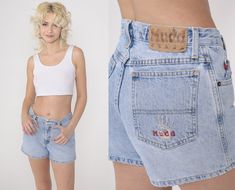 "Vintage 00s denim shorts by Mudd in blue denim with a mid rise waist. Please see measurements and condition below. Every garment we sell is authentic vintage! You will receive the exact item photographed. Condition: Very good vintage with light general wear. Best fits women's: Labelled size 3 Tag: Mudd Material:  Cotton MEASUREMENTS Taken from seam to seam while the garment is lying flat. Double the armpit, waist, and hips For reference, model is 5'7\" and measures 31-24-35. Waist: 14.5\" Hips: Y2k High Rise Fitted Shorts, Fitted Mid-rise Y2k Jean Shorts, Y2k Style Fitted Mid-rise Jean Shorts, Y2k Medium Wash Mid-rise Jean Shorts, Y2k Mid-rise Medium Wash Jean Shorts, Y2k Style Mid-rise Medium Wash Shorts, Y2k Mid-rise Medium Wash Shorts, Fitted Y2k Jean Shorts, Y2k Fitted Jean Shorts