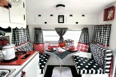 the interior of a camper with black and white polka dot curtains, red counter tops, and checkered cushions