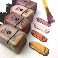 five different shades of nail polish sitting next to each other on a white table top