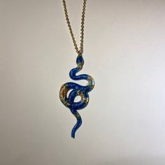 A beautiful handmade snake pendant. A great gift for a loved one or yourself! Each pendant is unique and one of a kind. This necklace is lightweight, durable. The gold necklace cord is 50.8cm(20in) in length with a gold lobster claw clasp. Other colours available in my store and more coming soon. If you have any request for any specific colour(s) or themes, feel free to contact me and I will see what I can do. :)  Custom orders available upon request, If you have any questions feel free to messa Large Pendant Snake Chain Necklaces For Gifts, Unique Adjustable Snake Chain Necklace, Handmade Snake-shaped Necklace For Gift, Unique Gold Snake Necklace, Handmade Snake Shape Necklace Gift, Handmade Snake Necklace For Gifts, Handmade Snake Shape Necklace For Gift, Unique Snake Shape Necklace For Gift, Spiritual Snake-shaped Necklace For Gifts