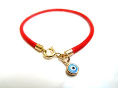 "Kabbalah good luck bracelet 14k gold red string Luxurious bracelet 14k solid Gold beautiful solid yellow 14 k gold and Italian leather bracelet delicate bracelet See description below: * Italian red embroidered leather cord 2.5mm * 14k solid gold and enamel evil eye charm - 6mm - 0.025gr * 14 k solid Gold end caps * 14 solid Gold spring closure *By Symbolina Evil eye: Is a sign of protection that also represents blessings, power, and strength, and is seen as potent in deflecting the evil eye. F Adjustable Yellow Gold Bracelets With Charms, Yellow Gold Evil Eye Jewelry For Good Luck, Yellow Gold Charms Bracelet For Good Luck, Yellow Gold Good Luck Charms Bracelets, Handmade 14k Gold Jewelry For Good Luck, Gold Evil Eye Jewelry For Blessing, Dainty Evil Eye Jewelry For Good Luck, 14k Gold Jewelry With Gold Clasp For Gift, Yellow Gold Evil Eye Bracelets As Gift