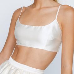 Ivory Premium Satin Spaghetti Strap Scoop Neck Micro Crop Top With Back Zip Closure New/Never Worn - Sold Out On Nastygal Elegant Sleeveless Cream Crop Top, Cream Camisole With Built-in Bra And Spaghetti Straps, Summer Wedding Tops With Delicate Straps, Elegant White Crop Top With Adjustable Straps, Elegant White Crop Top With Straps, Cream Spaghetti Strap Top With Built-in Bra, White Satin Tank Top For Summer, White Spaghetti Strap Top For Wedding, Chic White Satin Tank Top