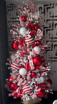 a red and white christmas tree with candy canes