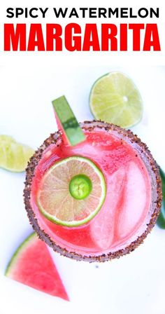 a close up of a drink with limes and watermelon