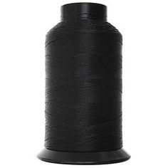 a spool of black thread on a white background