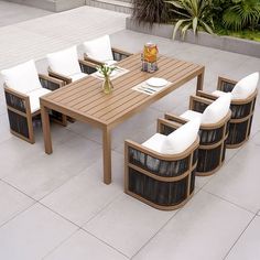 an outdoor dining table with six chairs around it