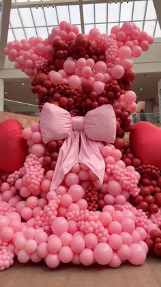 a large balloon sculpture with pink and red balloons