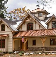 a large house with two story windows and an american flag on the front porch is shown