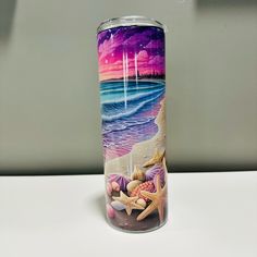 a can that is sitting on a table next to the ocean and starfishs