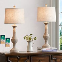 two lamps sitting on top of a wooden table