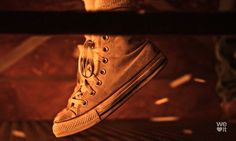 a person's shoe is seen through the bars in this artistic photo taken from below