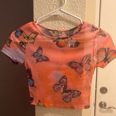 Fashion Nova Crop Top. Mesh See Thru. Size Xs (True To Size) No Tags But Never Worn And In 100% Perfect Condition. Open To Offers Printed Short Sleeve Crop Top For Spring, Printed Short Sleeve Crop Top, Multicolor Butterfly Print Top For Summer, Multicolor Butterfly Print Tops For Summer, Orange Short Sleeve Crop Top For Summer, Fitted Short Sleeve Top With Butterfly Print, Trendy Pink Butterfly Print Tops, Trendy Orange Short Sleeve Crop Top, Trendy Orange Crop Top For Spring