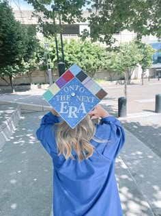 a woman wearing a blue graduation cap with the words, don't think new era on it