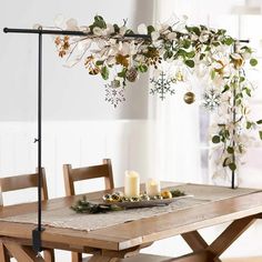 a table with candles and flowers on it in the middle of a dining room area