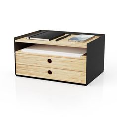 a wooden drawer with two drawers and a cell phone on the top, in front of a white background