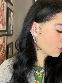 a woman with tattoos on her neck and ear piercings