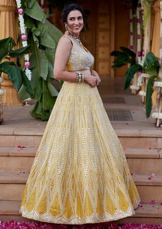 Geometric mirror and leather applique embroidered skirt in silver on yellow dupion silk fabric paired with heavily embroidered blouse and tulle dupatta with scallop border and pearl and sequence detailing. Yellow Sharara With Intricate Embroidery For Party, Yellow Organza Set With Intricate Embroidery, Yellow Organza Sets With Intricate Embroidery, Yellow Party Sets With Intricate Embroidery, Yellow Organza Lehenga With Intricate Embroidery, Yellow Organza Sharara With Intricate Embroidery, Yellow Organza Choli With Intricate Embroidery, Reception Yellow Sharara With Intricate Embroidery, Yellow Embellished Dress For Navratri