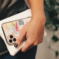 a woman is holding a white case with buttons on the front and side, in her hands