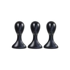 three black plastic mannequins sitting next to each other on a white background