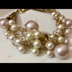 Freshwater Pearls Of Different Luster And Size Are Delicately Weaved With Non Tarnished Gold Wire. It Has Two Gold Cones To Add Texture. Some Pearls Are Small And White And Some Are Larger And Pink. Lots Of Details And A Gold Tone Clasp. Organic And On Trend. One Of A Kind. I Make Only One Piece At A Time. From A Smoke Free Home. Elegant White Wire Wrapped Pearl Bracelet, White Feminine Bracelets For Party, Feminine White Bracelets For Party, White Feminine Party Bracelets, Handmade Pink Pearl Bracelet, Handmade Pearl Beaded Bracelets For Party, Handmade Pearl Jewelry In Feminine Style, White Pearl Chain Bracelets For Party, Handmade Feminine Pearl Jewelry