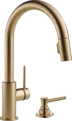 a brass colored faucet with two handles