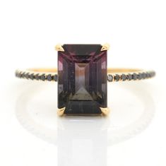 This Watermelon Tourmaline & Black Diamond Raven Ring is the perfect balance of mystery and elegance. Skillfully handcrafted, the unique tourmaline gem features a stunning gradation of colors that is modern and chic. Add this beautiful piece to your jewelry collection and stand out with its mesmerizing beauty. This Elegant Emerald Cut Tourmaline Jewelry, Elegant Tourmaline Jewelry With Center Stone, Modern Tourmaline Emerald Cut Rings, Modern Tourmaline Rings With Emerald Cut, Modern Tourmaline Rings In Emerald Cut, Formal Multi-stone Tourmaline Sapphire Ring, Elegant Emerald Cut Tourmaline Ring, Elegant Tourmaline Jewelry With Accent Stones, Elegant Emerald-cut Tourmaline Ring