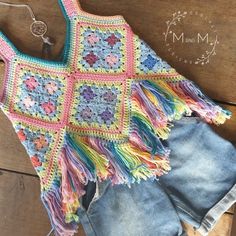 a crocheted top and shorts on a wooden floor