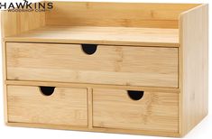 a wooden toy chest with two drawers and three black holes in the bottom drawer,